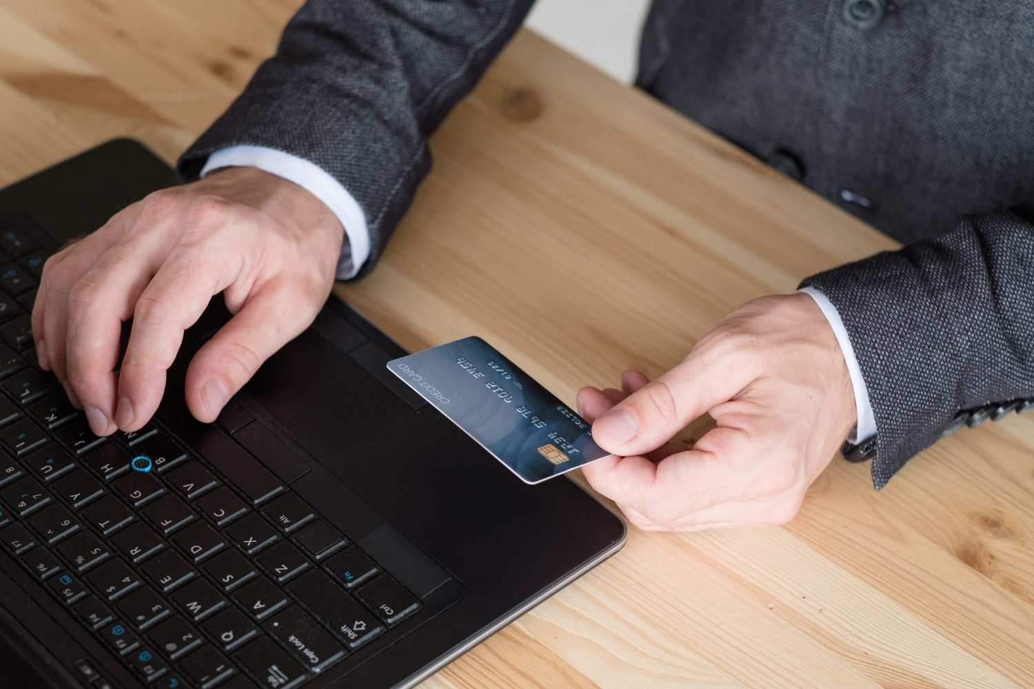 A Man Making An Online Payment Using A Credit Card