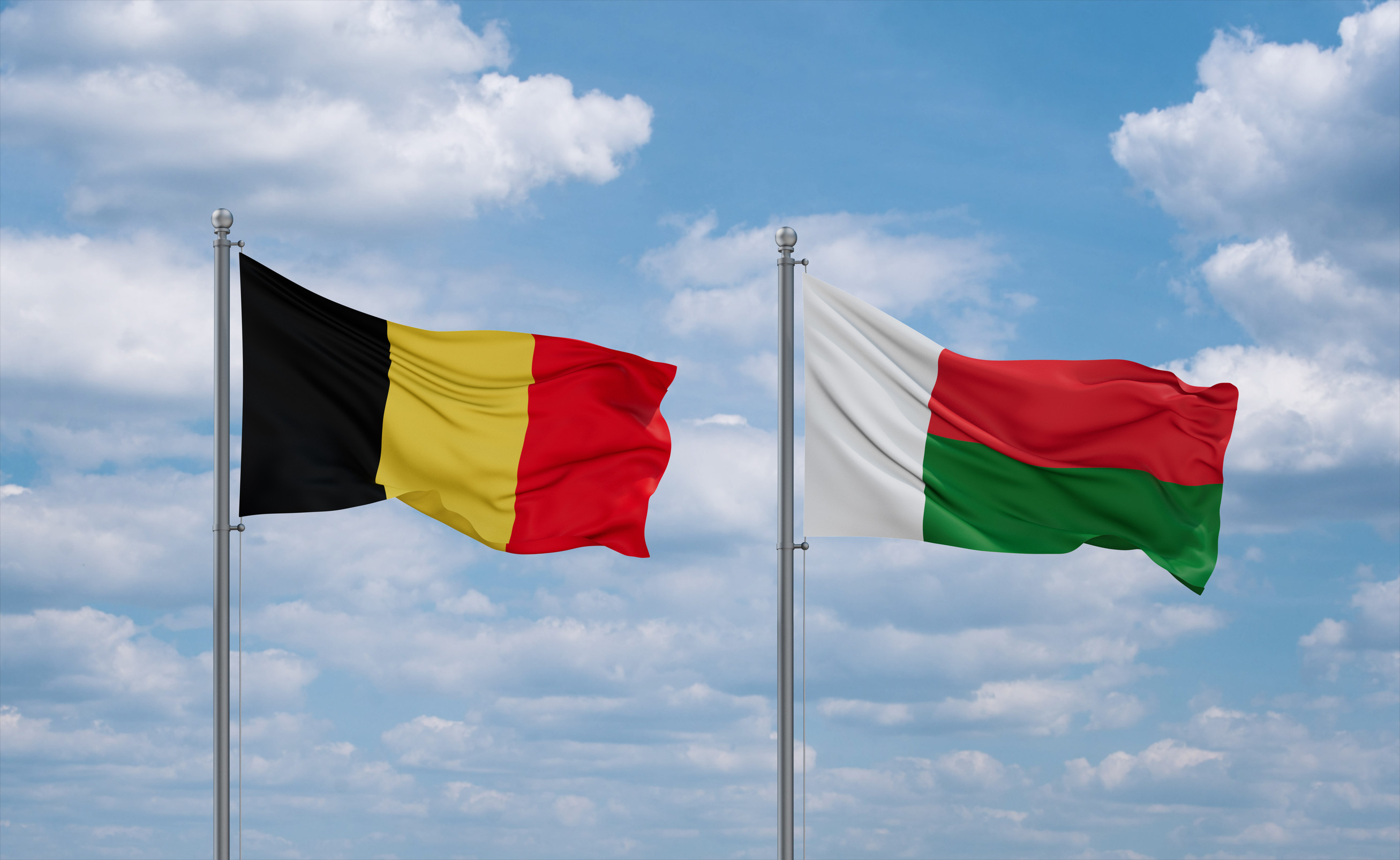 Belgium and Madagascar flags waving