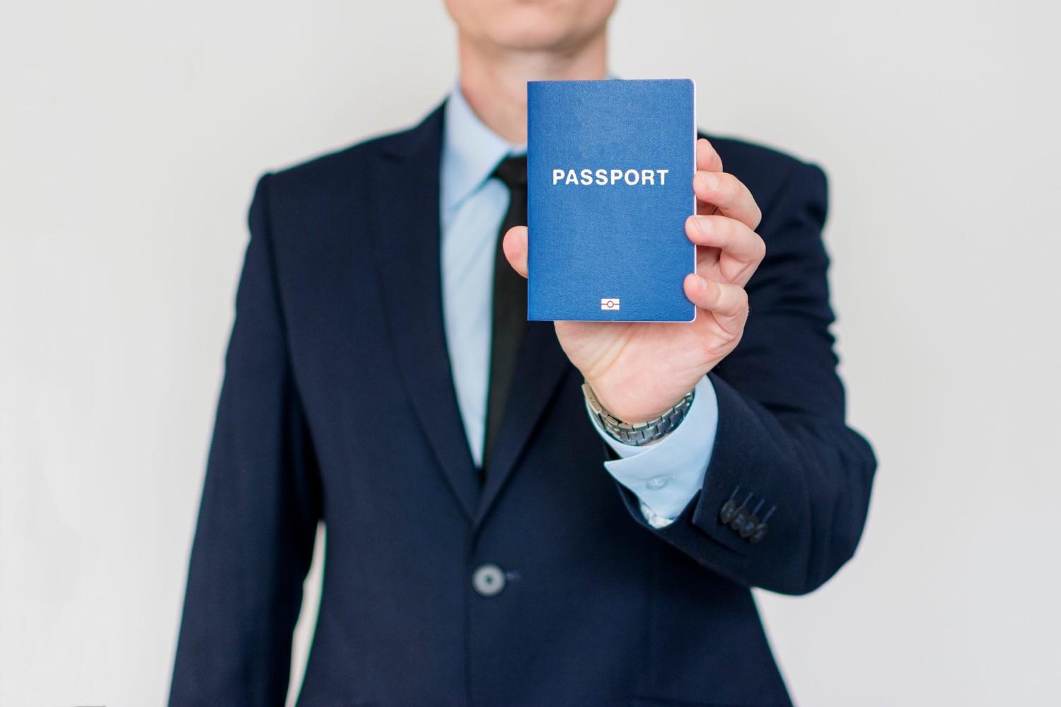 Businessman Holding Up A Passport