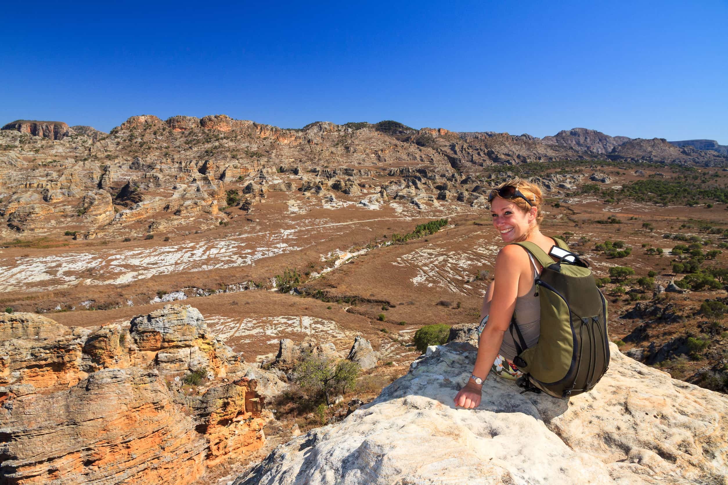 A tourist sitting on a rock at the Isalo National Park in Madagascar